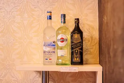 two bottles of alcohol sitting on a shelf at The Greenbelt Groove 1BR Makati 300MB swim gym park 4034 in Manila