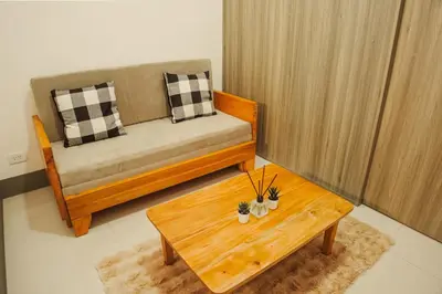 a living room with a couch and a coffee table at Fame Residences 1br unit by LaBelle in Manila