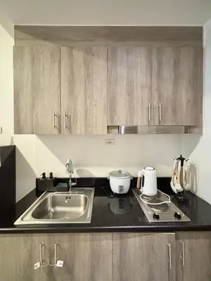 a kitchen with a sink and a counter top at Fame Residences 1br unit by LaBelle in Manila