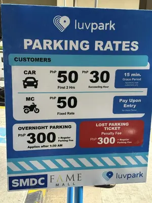 a sign for parking rates at a car dealership at Fame Residences 1br unit by LaBelle in Manila