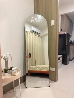 a mirror in the middle of a room with a bed at Fame Residences 1br unit by LaBelle in Manila