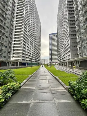 a walkway in the middle of two tall buildings at Fame Residences 1br unit by LaBelle in Manila