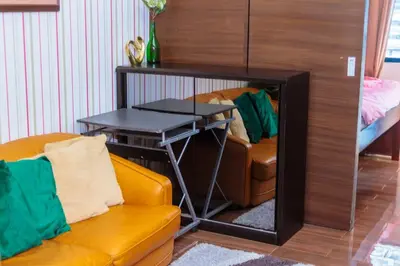a living room with a couch and a table at Makati Bliss Designer Stay Pool gym park Net300 makati 1767 in Manila