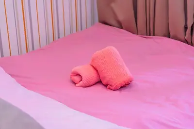 a pink stuffed animal laying on a pink bed at Makati Bliss Designer Stay Pool gym park Net300 makati 1767 in Manila