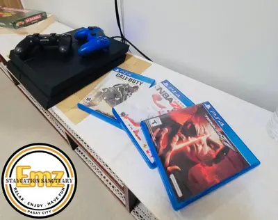 a table with a video game controller and a box at EMZ SHORE2 Staycation 18 in Manila