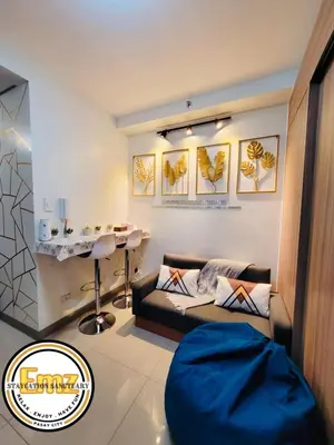 a living room with a couch and a table at EMZ SHORE2 Staycation 18 in Manila