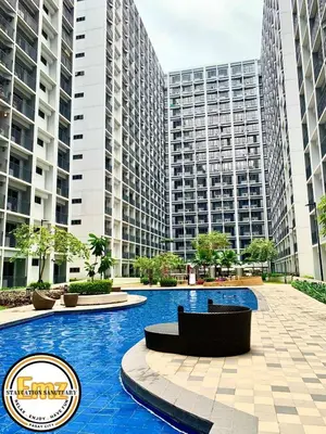 a swimming pool with tall buildings in the background at EMZ SHORE2 Staycation 18 in Manila