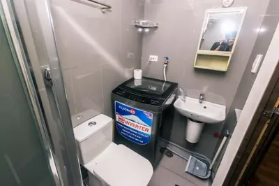a small bathroom with a toilet and a sink at Metro Paradise 1BR Comfort Makati swim gym park 300MB 2320 in Manila