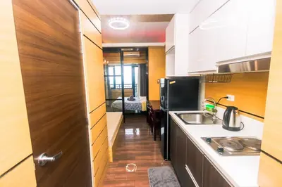 a small kitchen with a sink and a refrigerator at Metro Paradise 1BR Comfort Makati swim gym park 300MB 2320 in Manila
