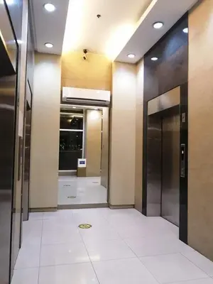 a hallway of a building with two elevators at 1BR Suite Ridgewood Towers Near BGC Airport #RW17-1 in Manila