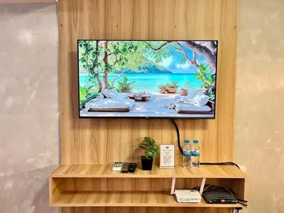 a flat screen tv hanging on a wall at 1BR Suite Ridgewood Towers Near BGC Airport #RW17-1 in Manila