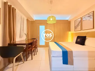 a hotel room with two beds and a table at Your Own Space Staycation in MOA in Manila