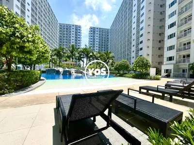 a group of benches in front of a swimming pool at Your Own Space Staycation in MOA in Manila