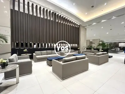 a lobby with couches and a large wall at Your Own Space Staycation in MOA in Manila
