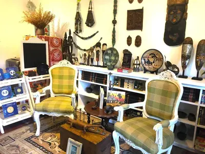 a room with two chairs andcellaneous items on a wall at Madie's Place B&B with Private Pool in Santa Rosa near Enchanted Kingdom in Santa Rosa