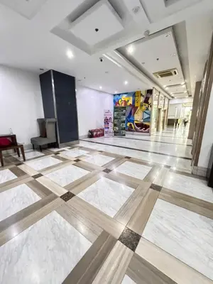 a room with a lobby with a wooden floor at Coziey Inn in Manila
