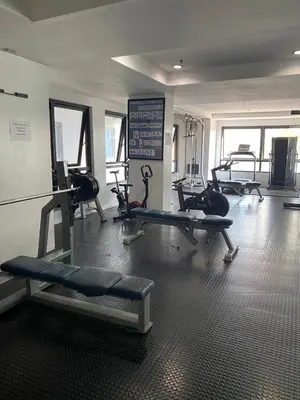 a gym with several treadms and machines in a room at Coziey Inn in Manila