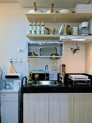 a kitchen with a sink and a microwave at Auberge Condotels B at SMDC Hope Residences in Trece Martires