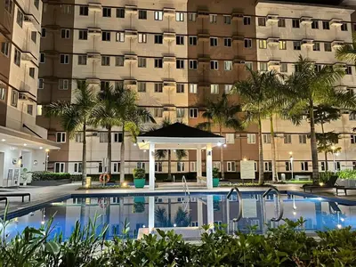 a swimming pool in front of a building at Auberge Condotels B at SMDC Hope Residences in Trece Martires