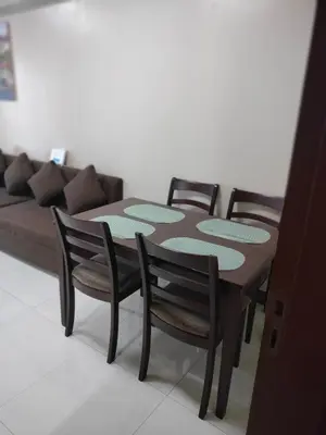 a table and four chairs in a living room with a couch at Rooms in Pasay City At Two Palm Tree Villas in Manila