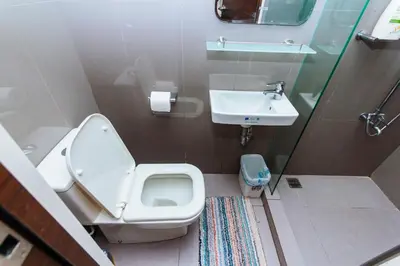 a bathroom with a toilet and a sink at Modern One BR Makati Condo Swim Gym Parking Netflix Fast 2428 in Manila