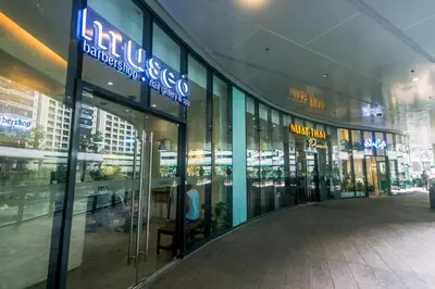 a shopping mall with a sign on the side of it at Netflix & Chill Stylish Makati condo gym swim park internet fast 2474 in Manila