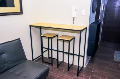 a table with two stools in a room at Suite Escape Luxe 1BR Makati condo Getaway Gym Swim Swim 2946 Fast MB in Manila