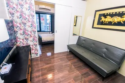 a living room with a couch in a room at Suite Escape Luxe 1BR Makati condo Getaway Gym Swim Swim 2946 Fast MB in Manila
