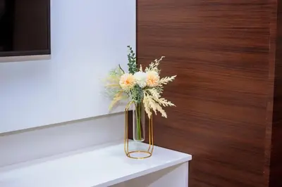 a vase filled with flowers sitting on a table at The Kings Condo Luxury 1BR Makati Ayala Gym Swim Parking Fast Internet 3058 in Manila