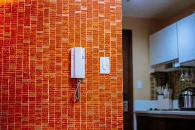 a phone on a brick wall in a kitchen at The Kings Condo Luxury 1BR Makati Ayala Gym Swim Parking Fast Internet 3058 in Manila