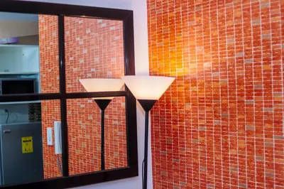 a brick wall with two vases in front of a window at The Kings Condo Luxury 1BR Makati Ayala Gym Swim Parking Fast Internet 3058 in Manila