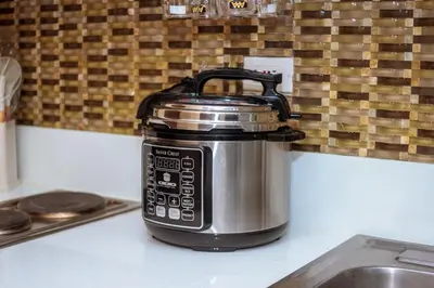a slow cooker sitting on top of a kitchen counter at The Kings Condo Luxury 1BR Makati Ayala Gym Swim Parking Fast Internet 3058 in Manila
