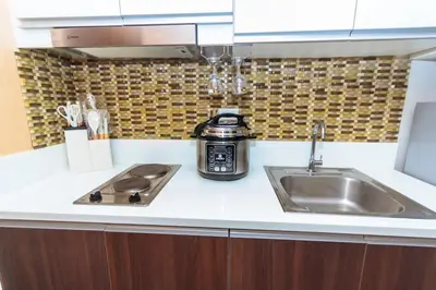 a toaster sitting on a kitchen counter next to a sink at The Kings Condo Luxury 1BR Makati Ayala Gym Swim Parking Fast Internet 3058 in Manila