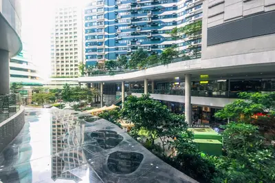 a view of a building with trees and buildings at The Kings Condo Luxury 1BR Makati Ayala Gym Swim Parking Fast Internet 3058 in Manila