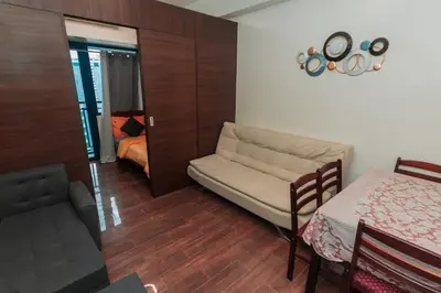 a living room with a couch and a bed at Urban Luxe 1BR Makati central gym swim Park Fast Internet MB 3301 in Manila