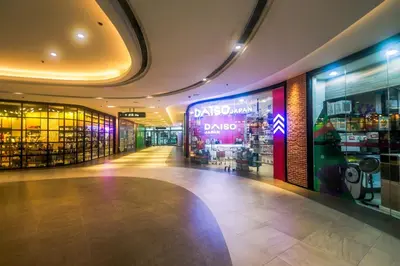 a shopping mall with a dacus sign on the wall at City Best Designer 1BR Makati Fast internet Gym Swim Park 2050 in Manila