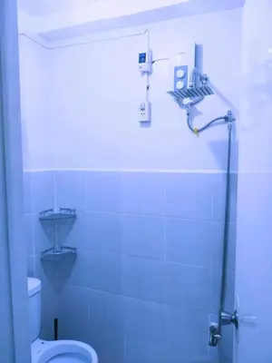 a bathroom with a shower and a toilet in it at Eurica transient Inn Near Terminal 3 in Manila