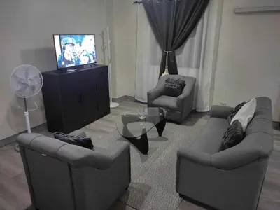 a living room with two couches and a television at LDN Pinecrest Two-room Suite in Manila