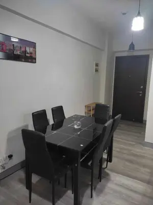 a black dining table with black chairs in a room at LDN Pinecrest Two-room Suite in Manila