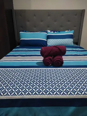 a bed with two red towels sitting on it at LDN Pinecrest Two-room Suite in Manila