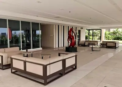 a lobby with couches and a statue in a building at City Escape in Manila