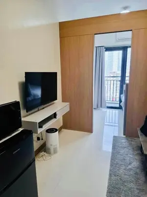 a living room with a flat screen tv on a counter at City Escape in Manila