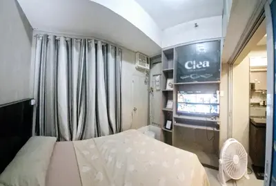 a small room with a bed and a fan at MEZZA TOWER 2 SMARTTV 43inch in Manila