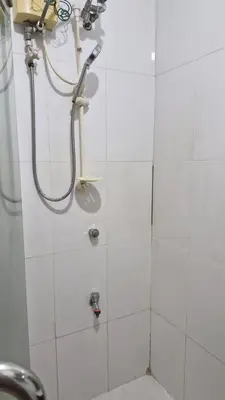 a bathroom with a shower with a shower head at MEZZA TOWER 2 SMARTTV 43inch in Manila