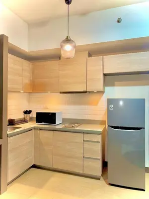 a kitchen with a refrigerator and a microwave at Condo Venice Luxury Residences Grand canal View in Manila