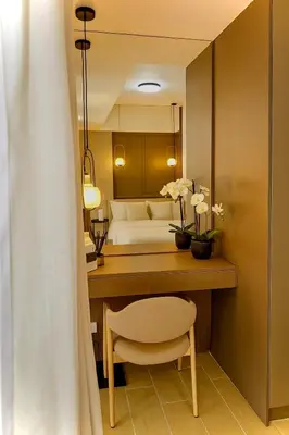 a room with a desk with a chair and a couch at Condo Venice Luxury Residences Grand canal View in Manila