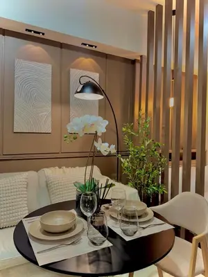 a dining room with a table with plates and wine glasses at Condo Venice Luxury Residences Grand canal View in Manila