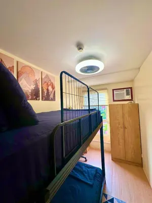 a bedroom with a bunk bed in a room at Cattleya Hearthstone in Manila