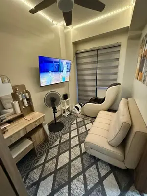 a living room with a couch and a flat screen tv at Fred Erick Staycation in Manila
