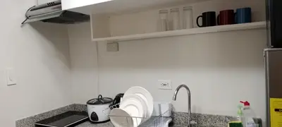 a kitchen counter with plates and a sink at Fred Erick Staycation in Manila